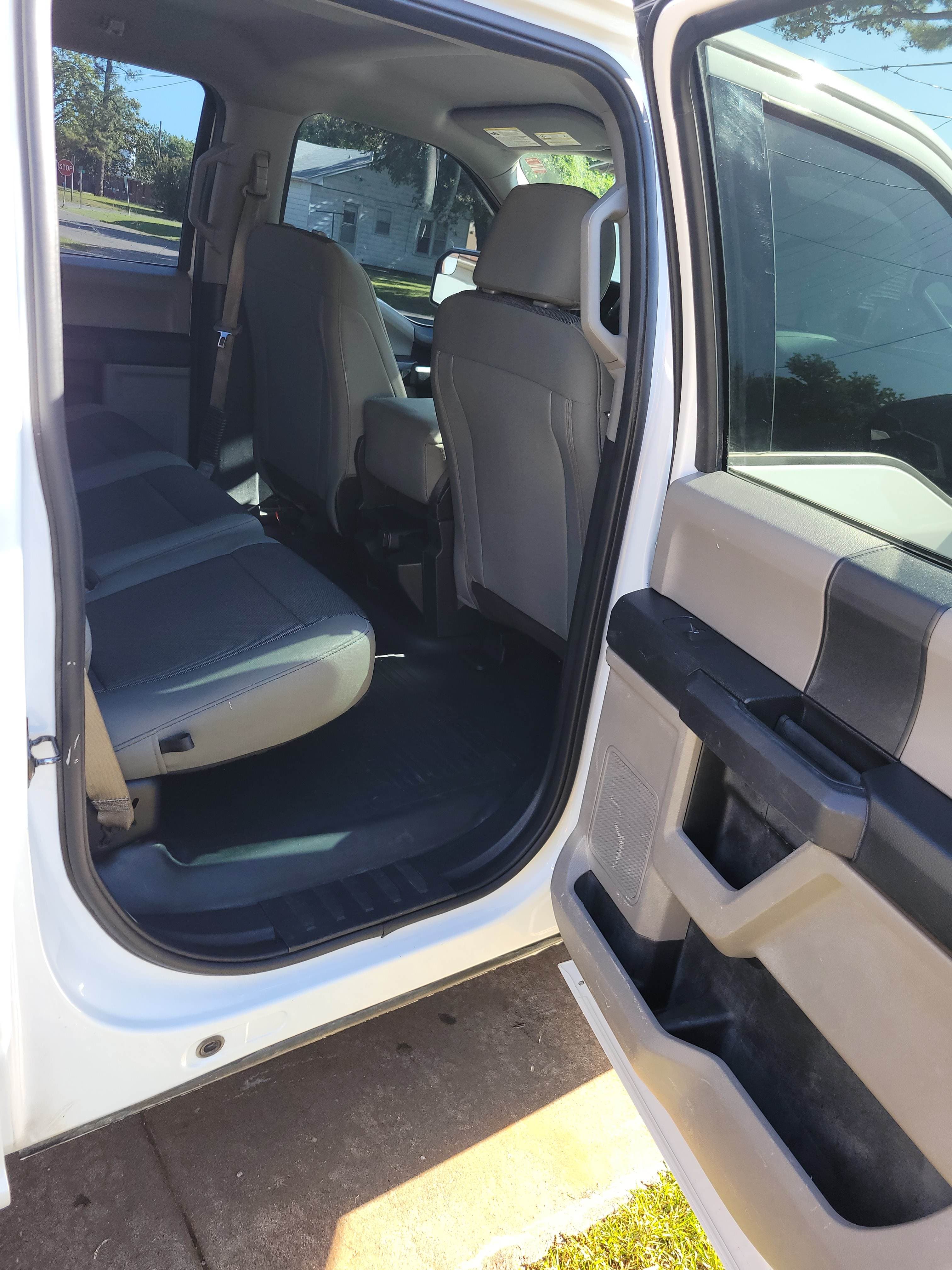 Clean rear interior of a white F-150 after detailing in Edmond