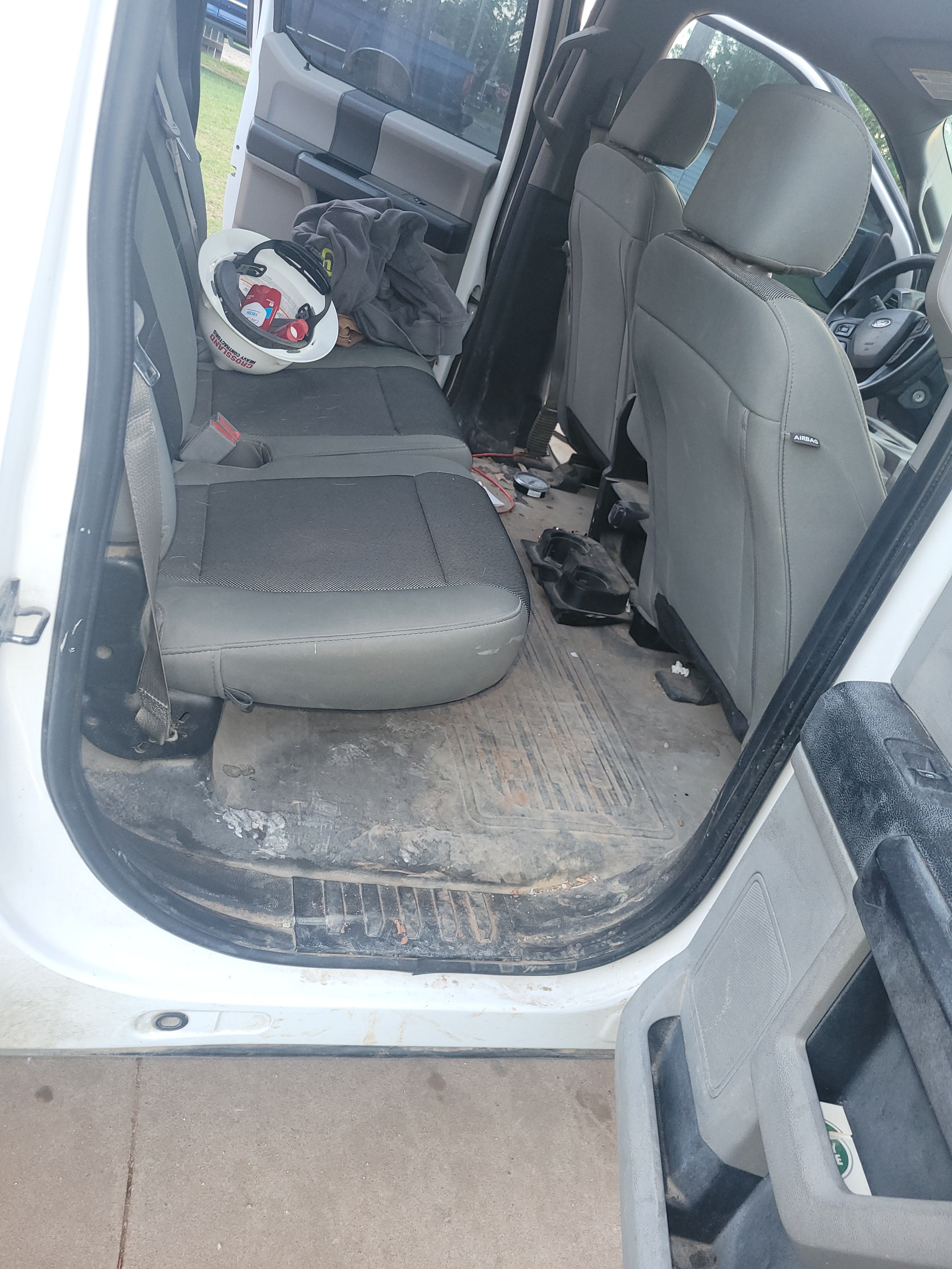 Dirty interior of a white work truck before detailing